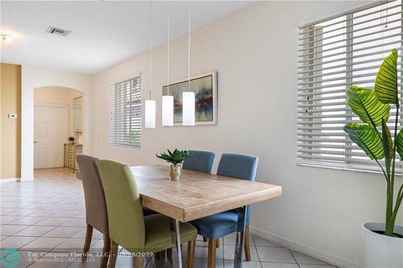 656 Conservation Drive Weston, FL 33327 - Photo 16 of 30 a view of a dining room with furniture and window