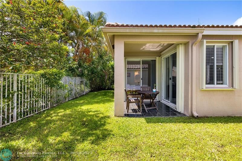 656 Conservation Drive Weston, FL 33327 - Photo 30 of 30 a view of a chair and table in the garden
