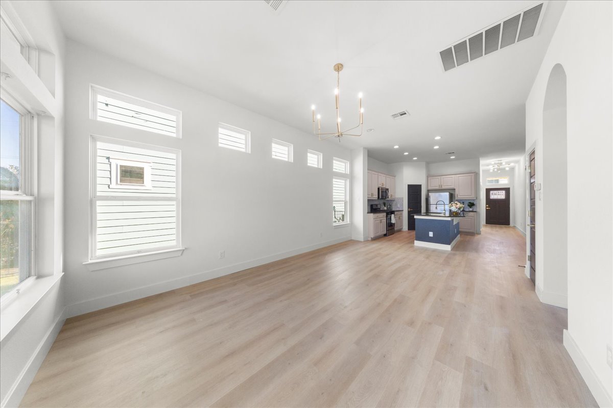 2408 Vintage Stave Road, Unit 101 Austin, TX 78748 - Photo 11 of 32 Unfurnished living room featuring a chandelier, light wood-style flooring, and recessed lighting