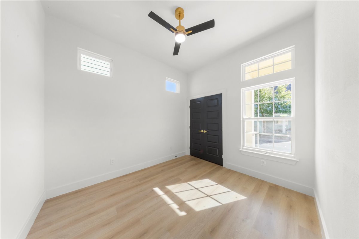2408 Vintage Stave Road, Unit 101 Austin, TX 78748 - Photo 15 of 32 Empty room with ceiling fan and light wood-style flooring
