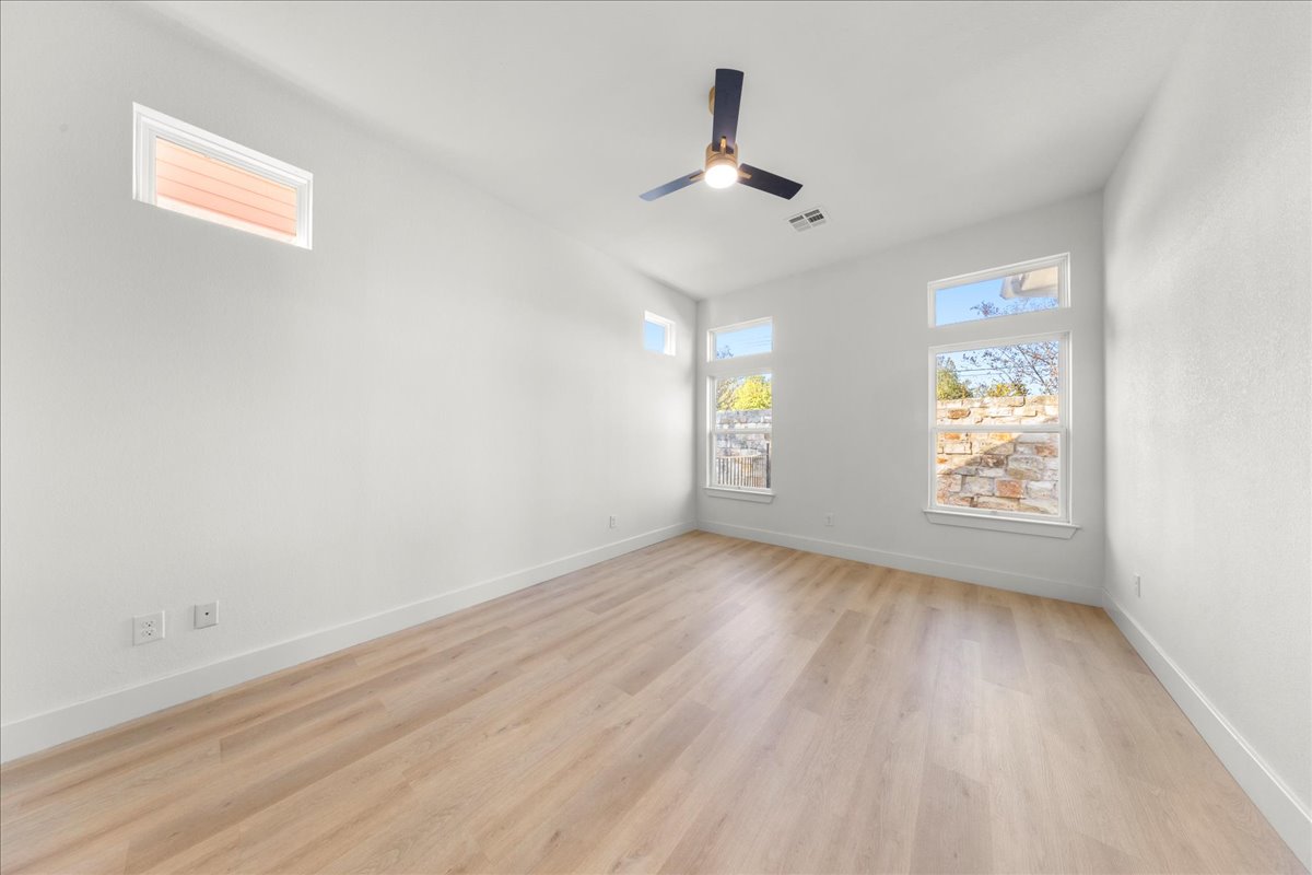 2408 Vintage Stave Road, Unit 101 Austin, TX 78748 - Photo 19 of 32 Spare room featuring light wood-style floors and ceiling fan