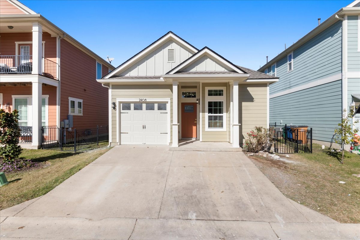 2408 Vintage Stave Road, Unit 101 Austin, TX 78748 - Photo 2 of 32 View of front of house featuring board and batten siding, concrete driveway, and a gate