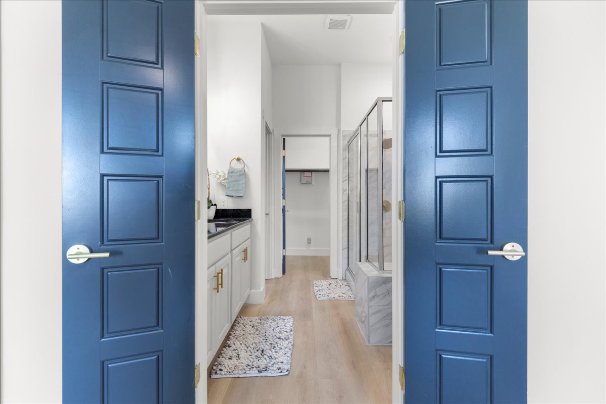 2408 Vintage Stave Road, Unit 101 Austin, TX 78748 - Photo 21 of 32 Bathroom featuring vanity, a shower stall, and light wood-type flooring