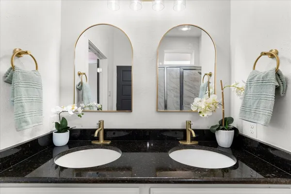 a bathroom with 2 sink bathtub and a mirror