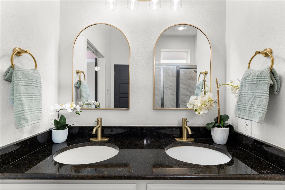 2408 Vintage Stave Road, Unit 101 Austin, TX 78748 - Photo 23 of 32 Full bath with double vanity and a shower stall