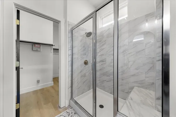 a bathroom with a glass shower door