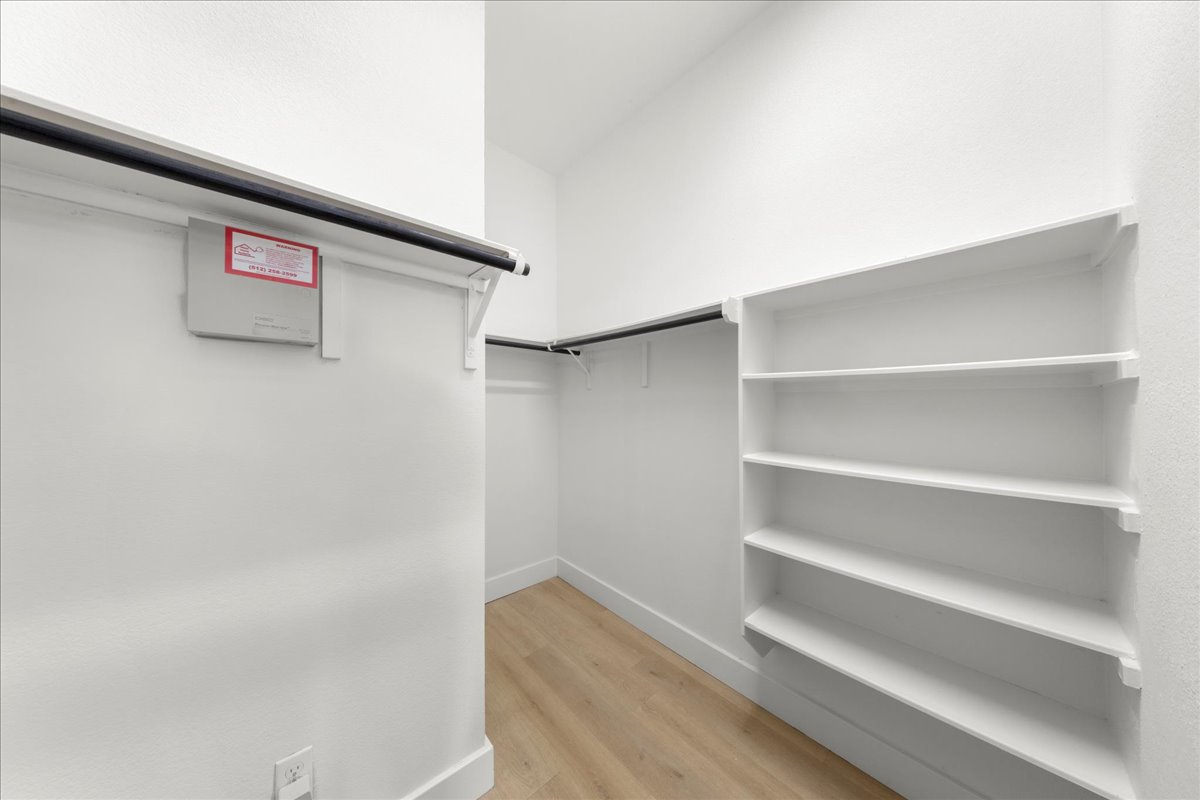2408 Vintage Stave Road, Unit 101 Austin, TX 78748 - Photo 25 of 32 Walk in closet featuring light wood-type flooring