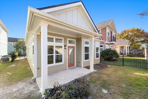 a view of a house with backyard and porch