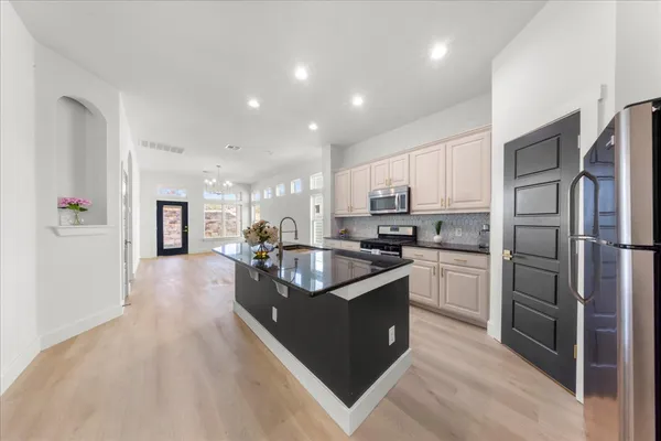 a kitchen with refrigerator and cabinets
