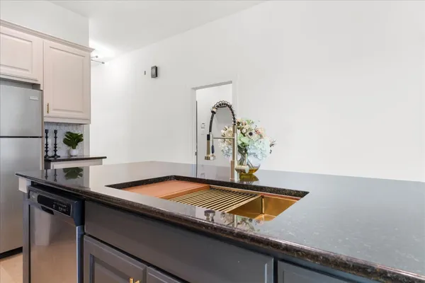 a kitchen with a sink cabinets and window