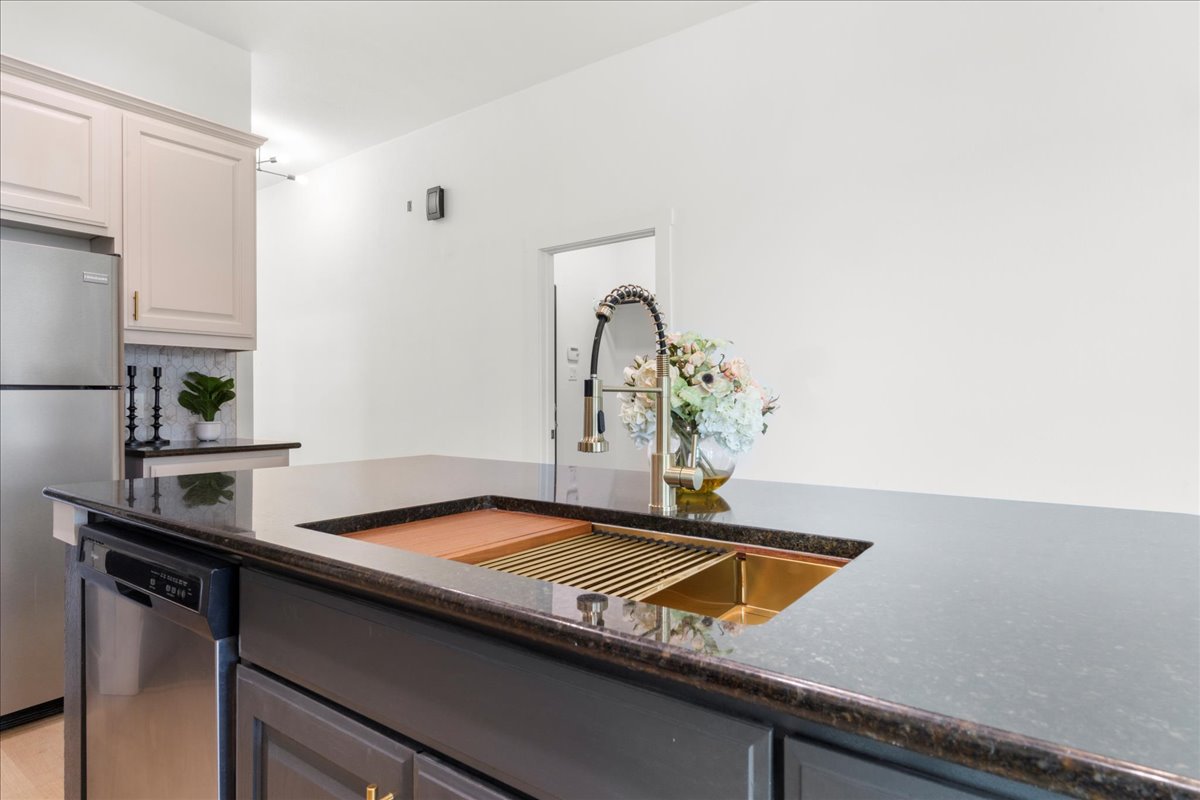 2408 Vintage Stave Road, Unit 101 Austin, TX 78748 - Photo 7 of 32 Kitchen featuring appliances with stainless steel finishes, dark stone countertops, and tasteful backsplash