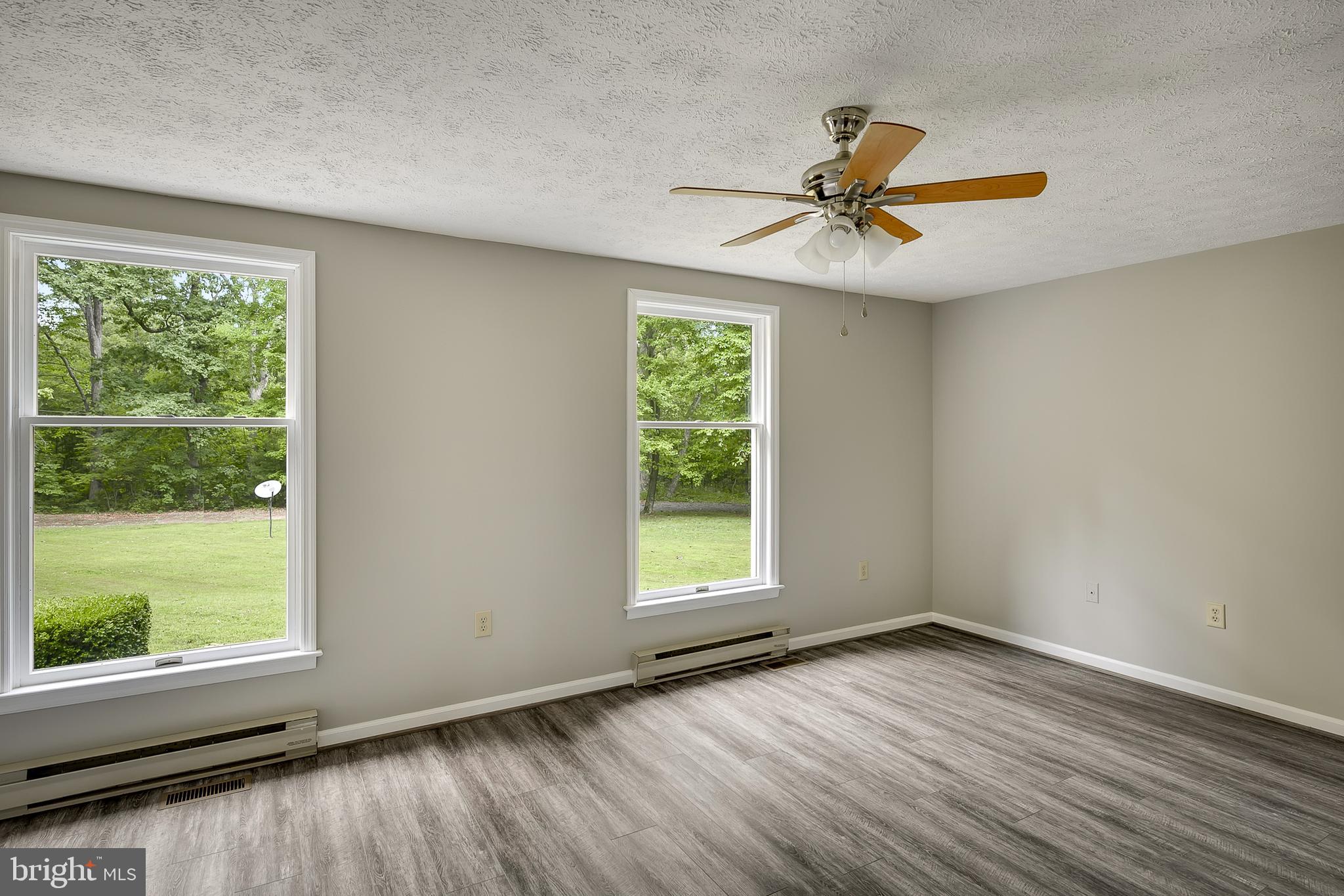 1504 New Hope Road Cross Junction, VA 22625 - Photo 10 of 35 an empty room with wooden floor fan and windows