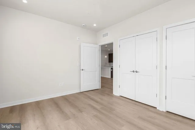 a kitchen with a sink a window and wooden floor