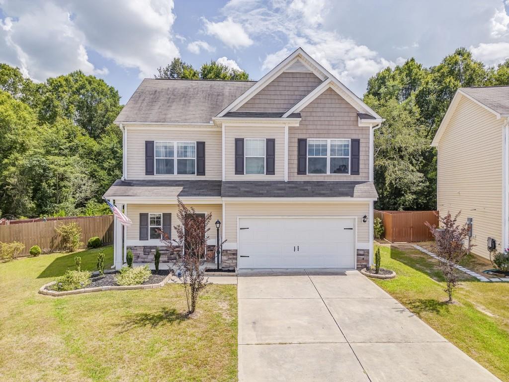 a view of house with swimming pool and sitting area