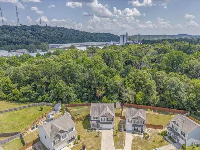an aerial view of a house with a garden and lake view