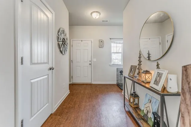 a view of an entryway with wooden floor