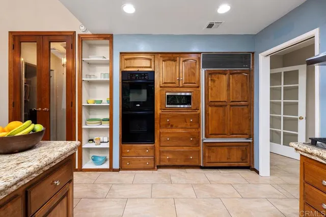 a view of kitchen with stainless steel appliances granite countertop cabinets and sink