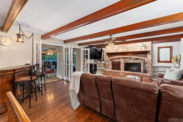a living room with fireplace furniture and a floor to ceiling window
