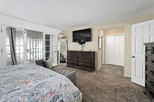 a bedroom with a bed and a television in it