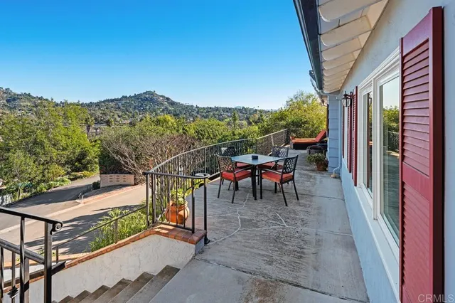 a view of a chairs and table in the balcony