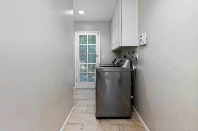 a utility room with wooden floor washer and dryer