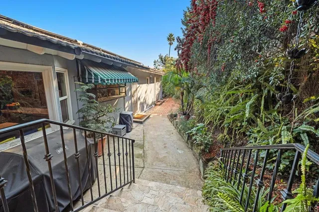 a view of balcony with wooden floor and fence
