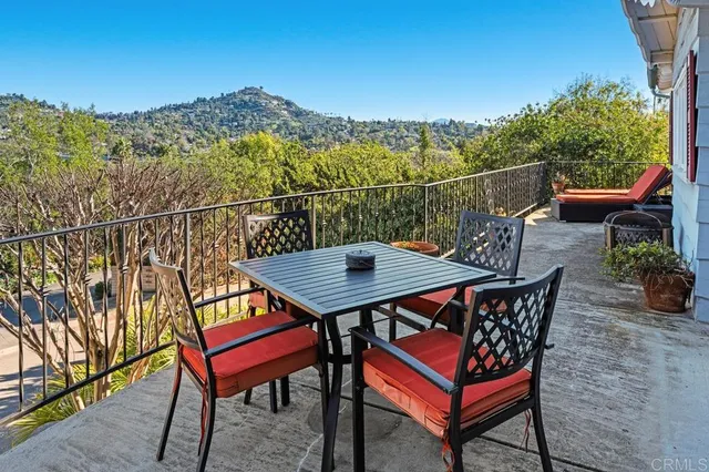 a view of a terrace with a table and chairs