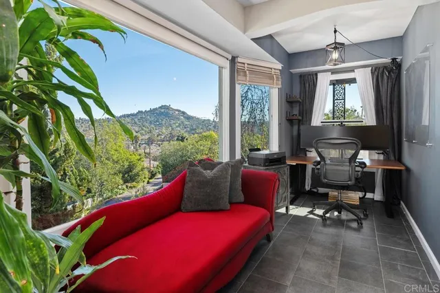 a living room with furniture and a floor to ceiling window