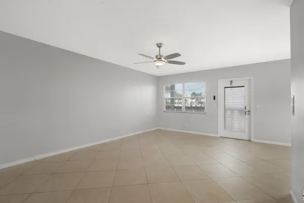 an empty room with closet and windows