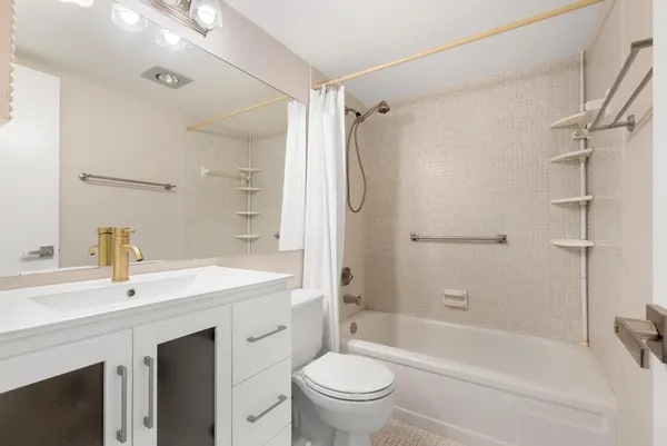 a bathroom with a sink toilet vanity and shower