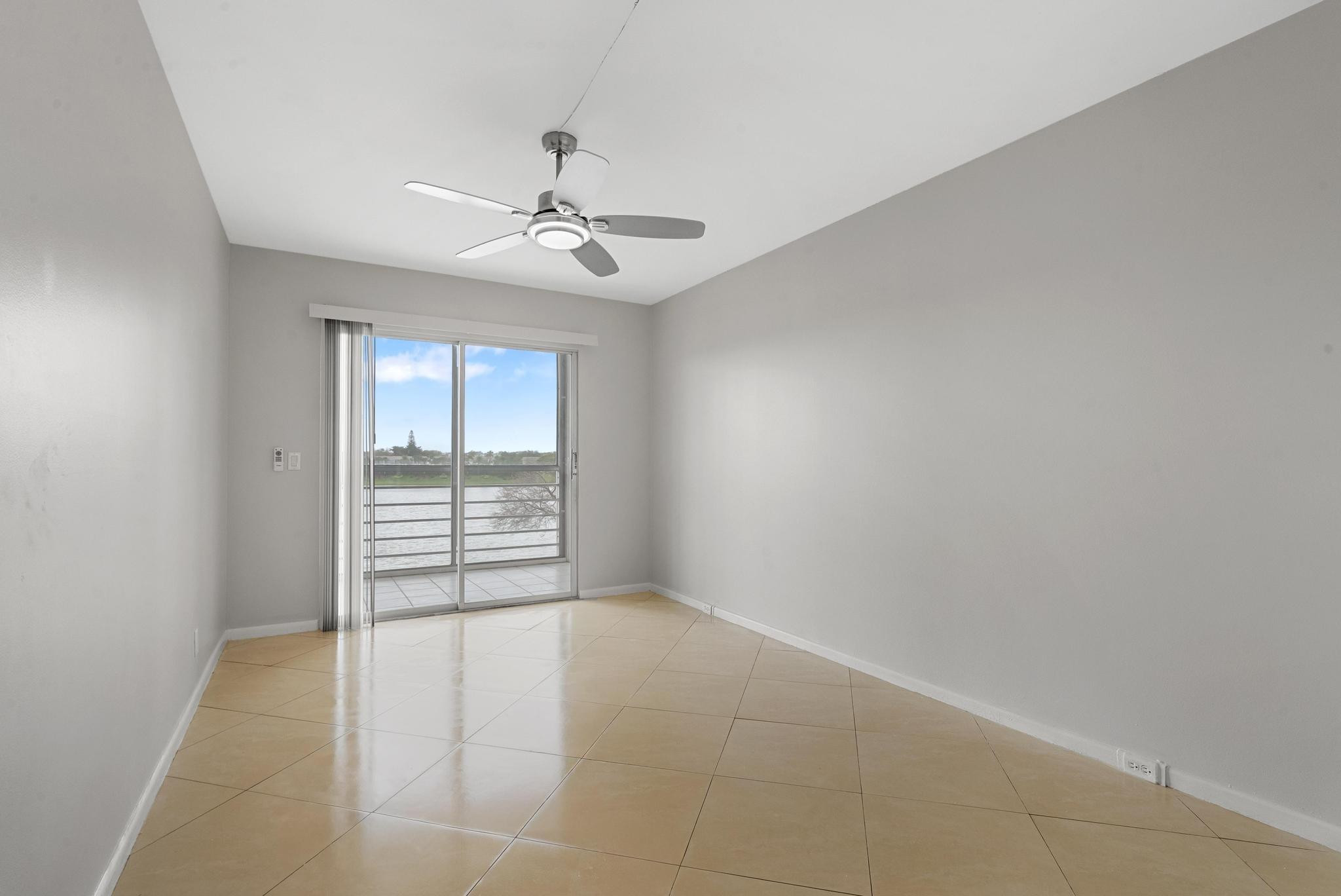 3038 Cornwall East, Unit 3038 Boca Raton, FL 33434 - Photo 15 of 32 an empty room with windows and fan