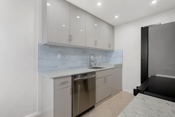 a kitchen with a sink and a refrigerator