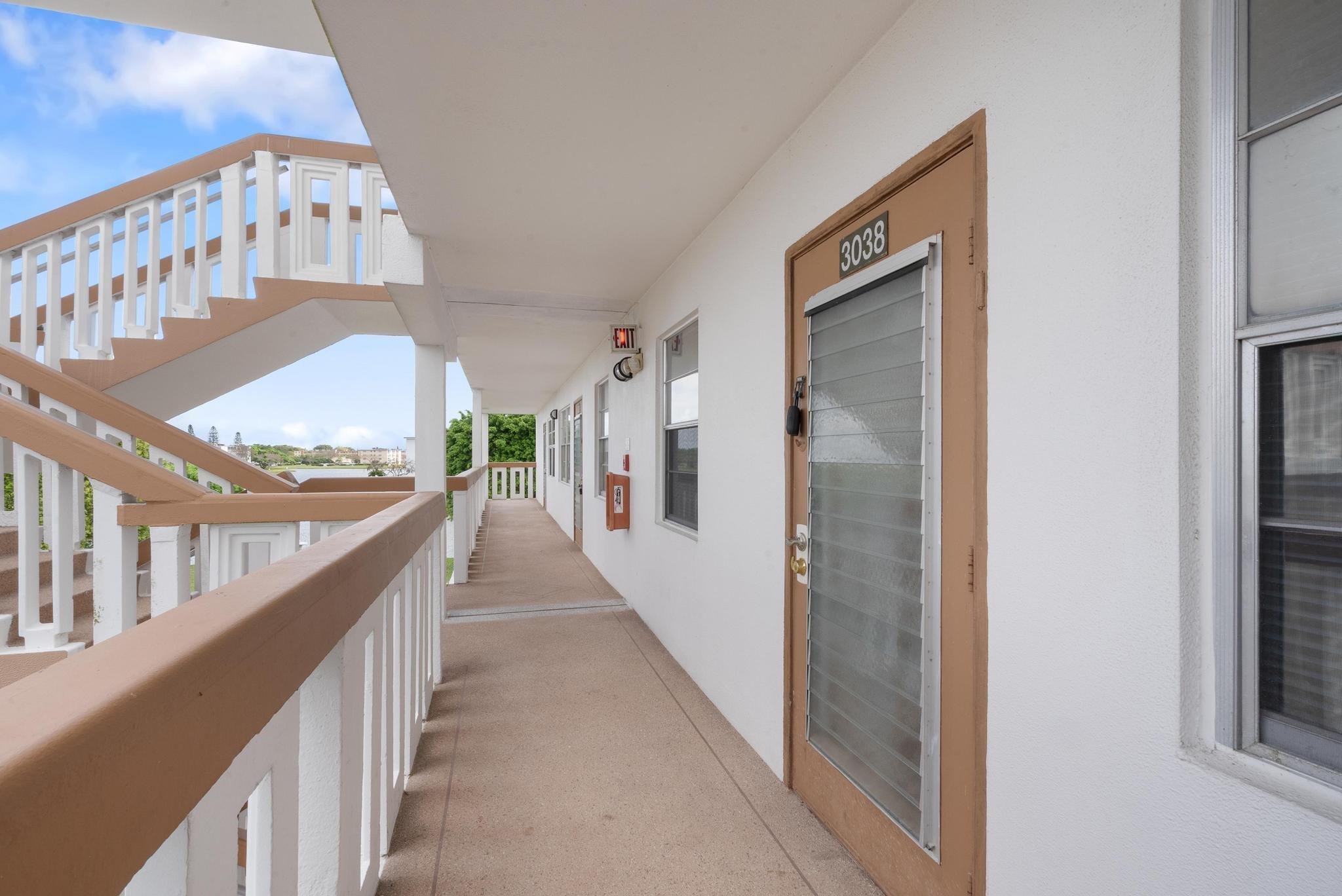 3038 Cornwall East, Unit 3038 Boca Raton, FL 33434 - Photo 22 of 32 a view of staircase with railing and white walls