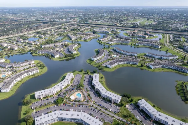 an aerial view of a house with a lake