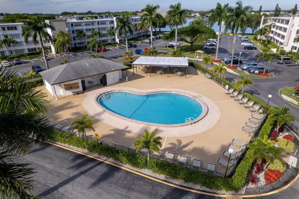 an aerial view of a swimming pool lawn chairs and yard