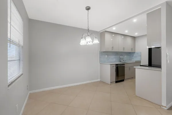 a kitchen with a stove a refrigerator and a sink