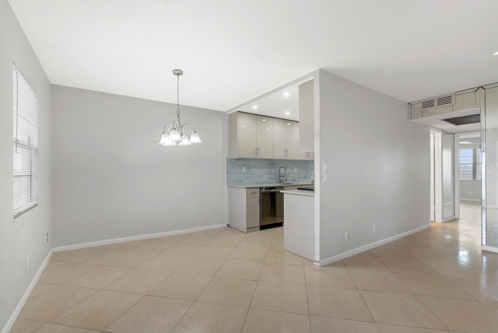 3038 Cornwall East, Unit 3038 Boca Raton, FL 33434 - Photo 5 of 32 a view of a kitchen with a sink and a window