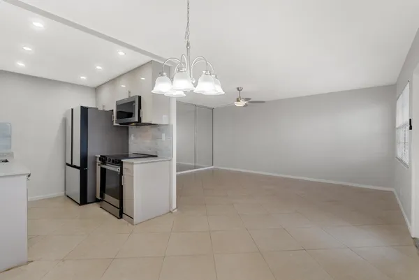 a kitchen with stainless steel appliances a refrigerator sink and stove