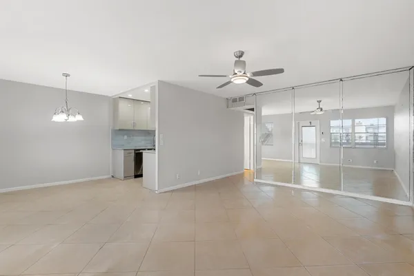an empty room with fireplace and windows
