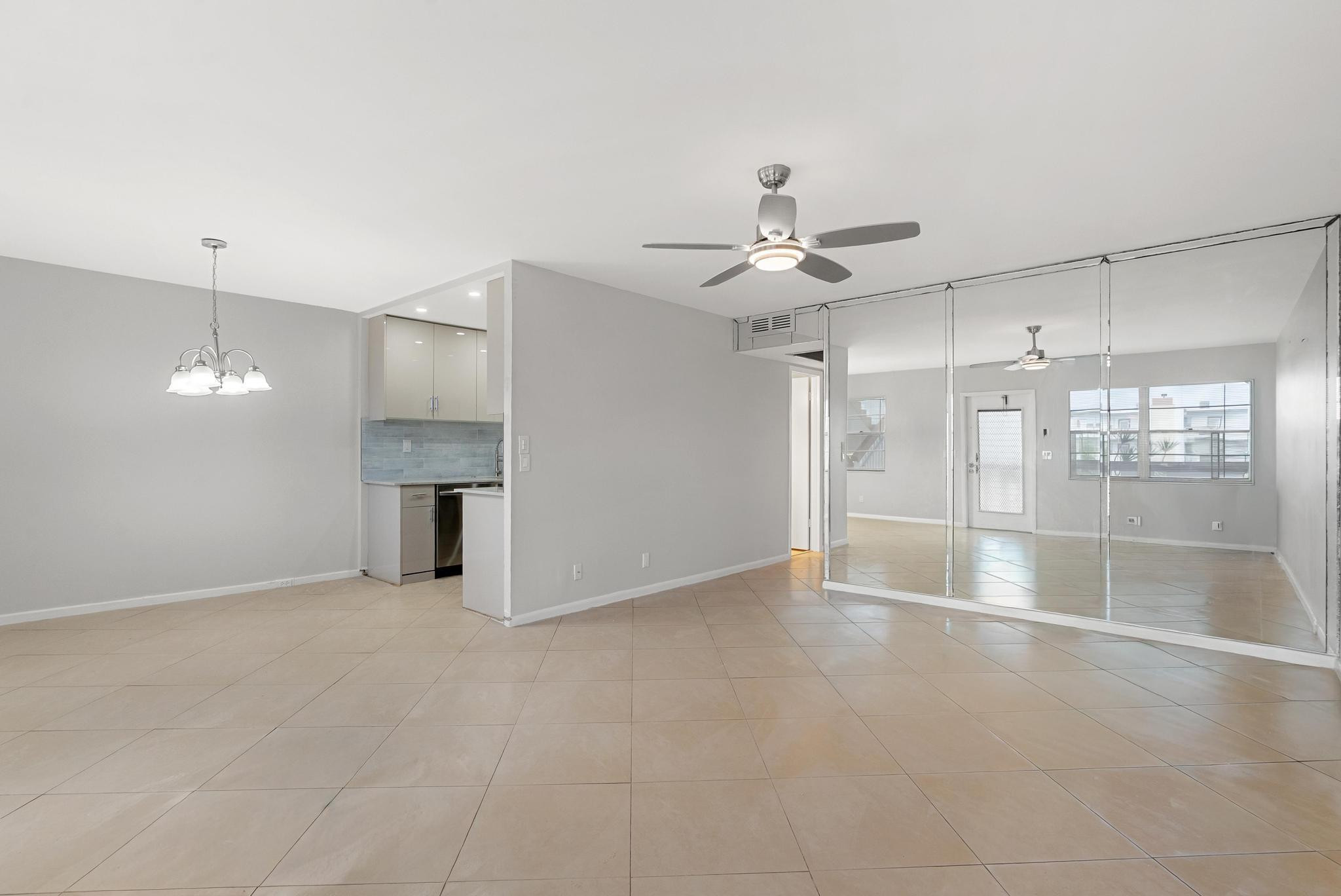 3038 Cornwall East, Unit 3038 Boca Raton, FL 33434 - Photo 8 of 32 an empty room with fireplace and windows