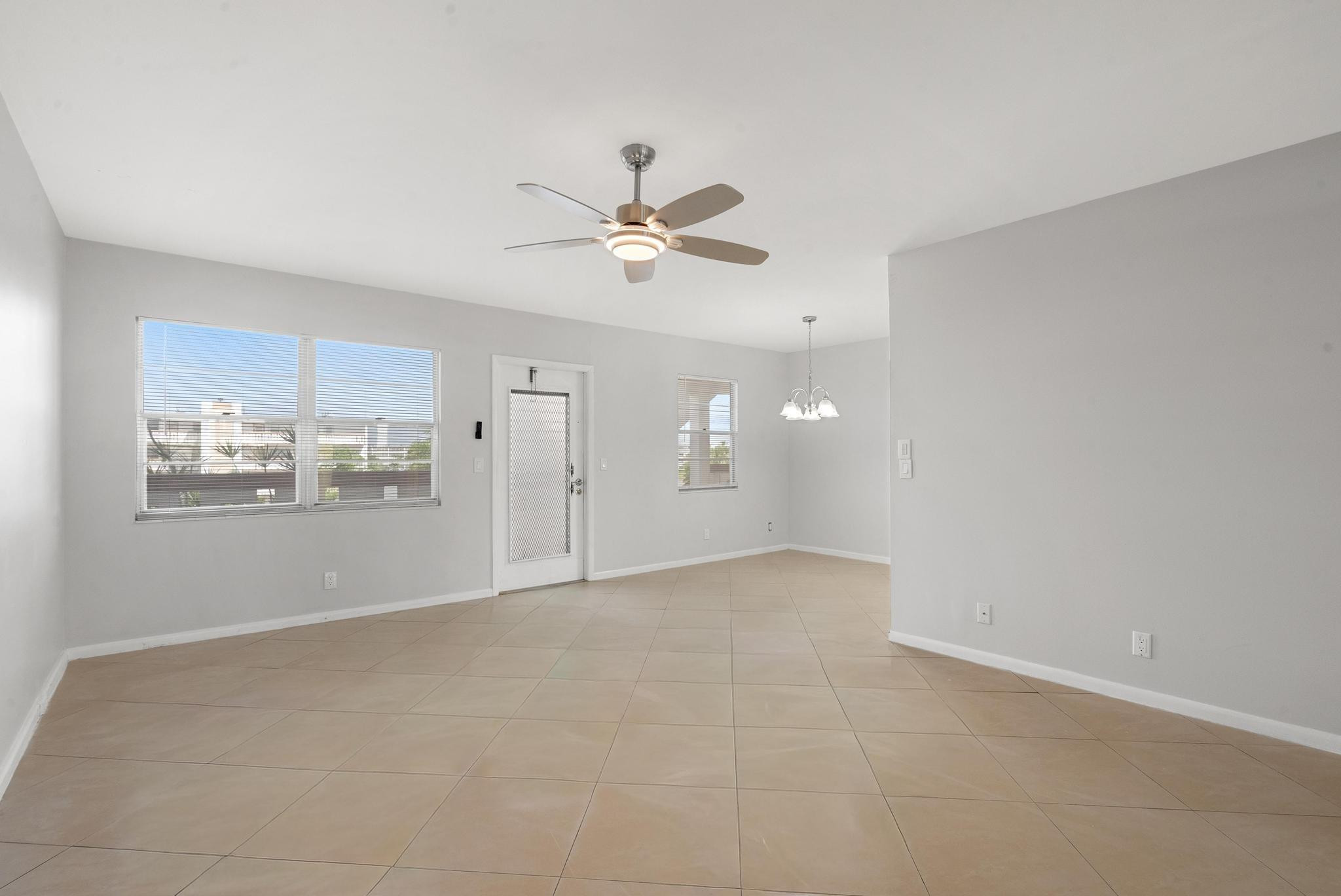 3038 Cornwall East, Unit 3038 Boca Raton, FL 33434 - Photo 9 of 32 a view of a big room with a kitchen and a chandelier fan