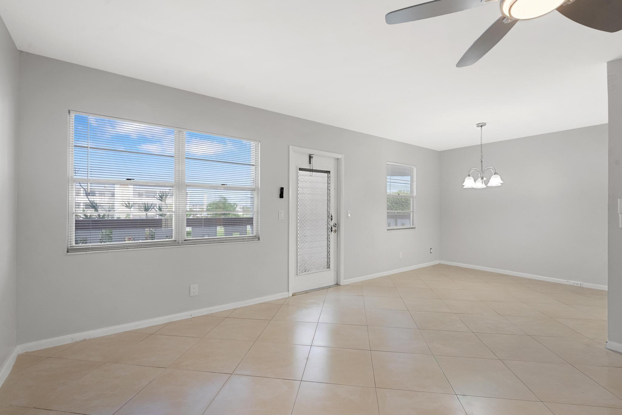 3038 Cornwall East, Unit 3038 Boca Raton, FL 33434 - Photo 10 of 32 a view of an empty room with kitchen