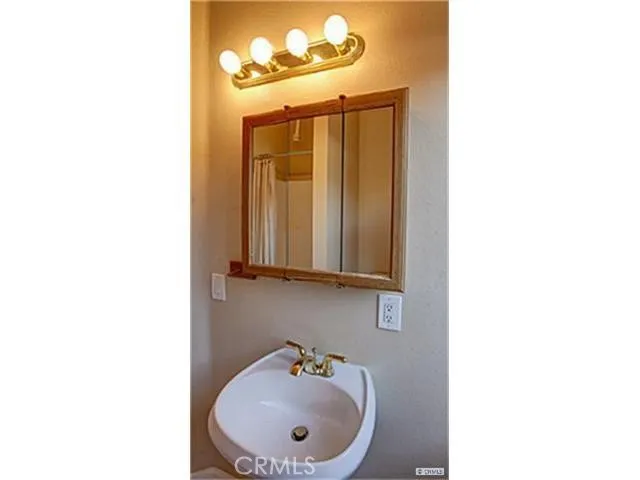 a bathroom with a sink a mirror and vanity