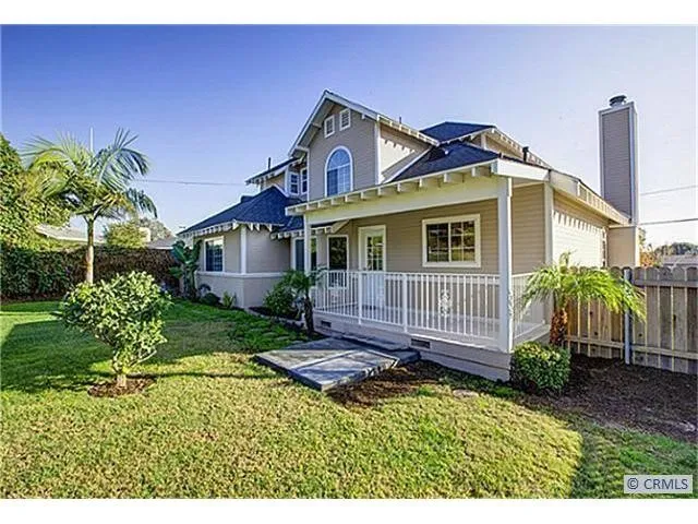 a front view of a house with a garden and plants