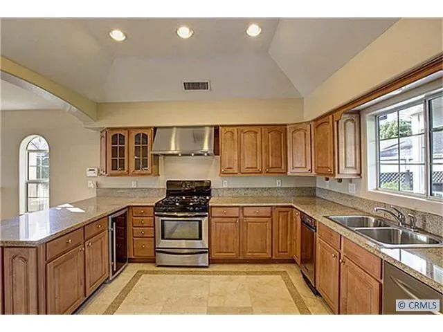 a kitchen with a sink stove and cabinets