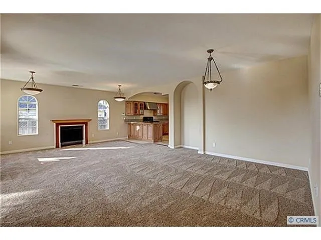 a view of empty room with a fireplace