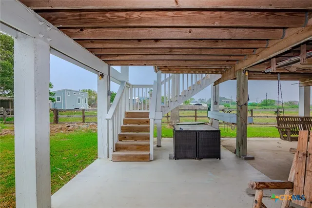 a view of a porch with furniture and garden
