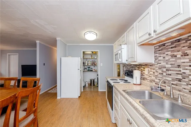 a kitchen with stainless steel appliances granite countertop a sink dishwasher stove and refrigerator