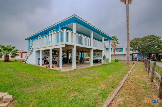 a view of a house with a yard balcony and a patio
