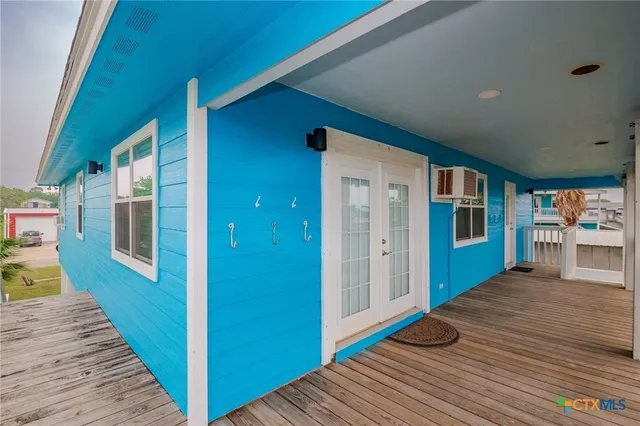 a view of a balcony with wooden floor & fence